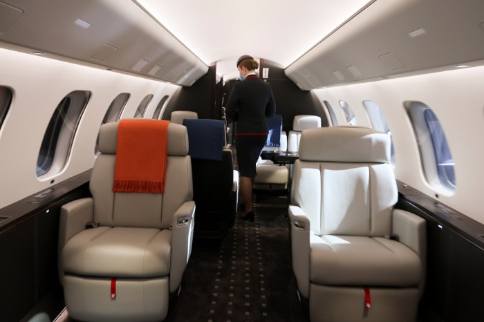 O stewardesă de cabină VistaJet se plimbă prin interiorul unui nou avion de afaceri Bombardier Global 7500 
