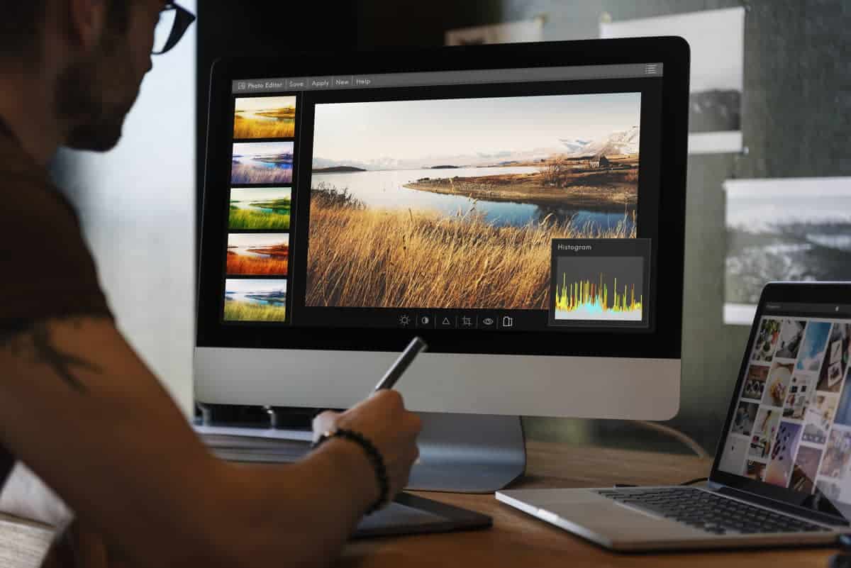 man editing photos computer